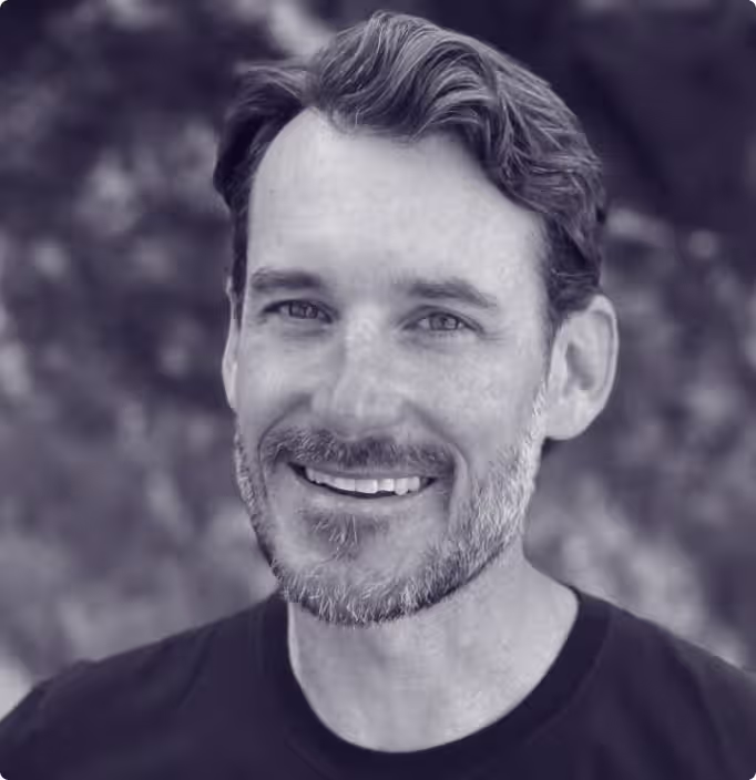 Smiling man with a beard and medium-length hair, featured on the Faros AI website.