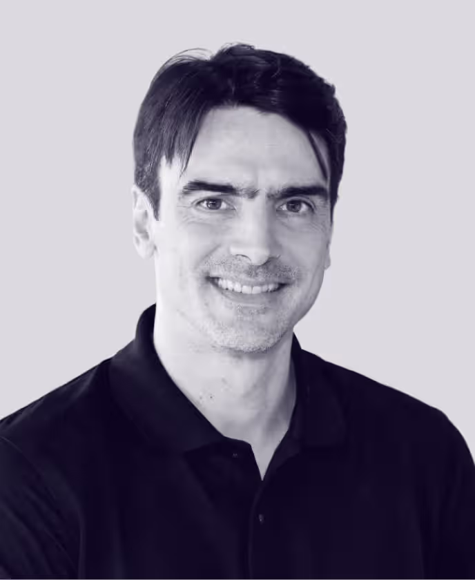 Professional headshot of a man in a black polo shirt, used to represent a staff member on the Faros AI website.