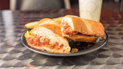 A sandwich cut in half on a plate.