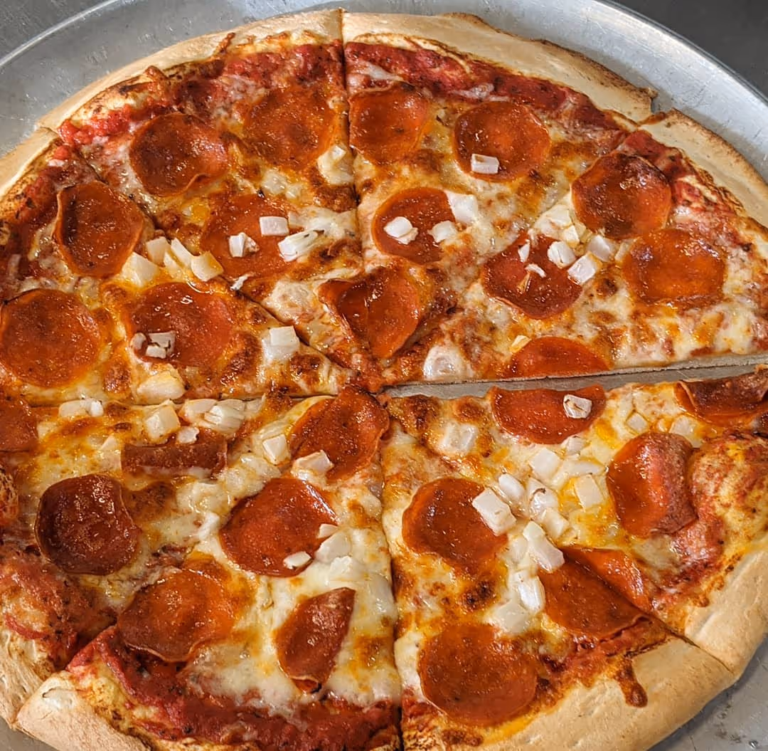 A pepperoni pizza with white cheese and pepperoni slices.