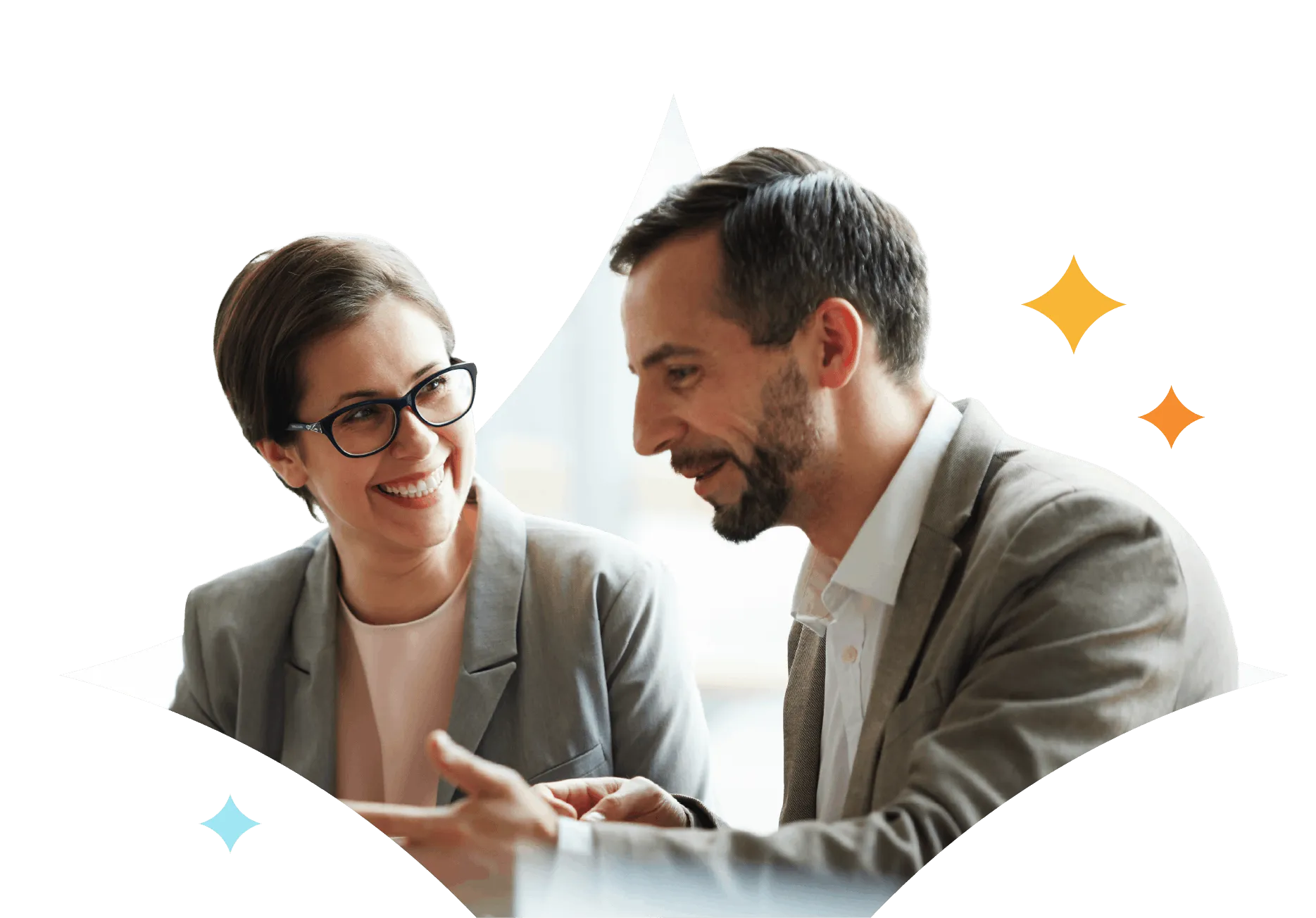 Two business professionals, a woman with glasses and a man with a beard, engaged in a friendly discussion.