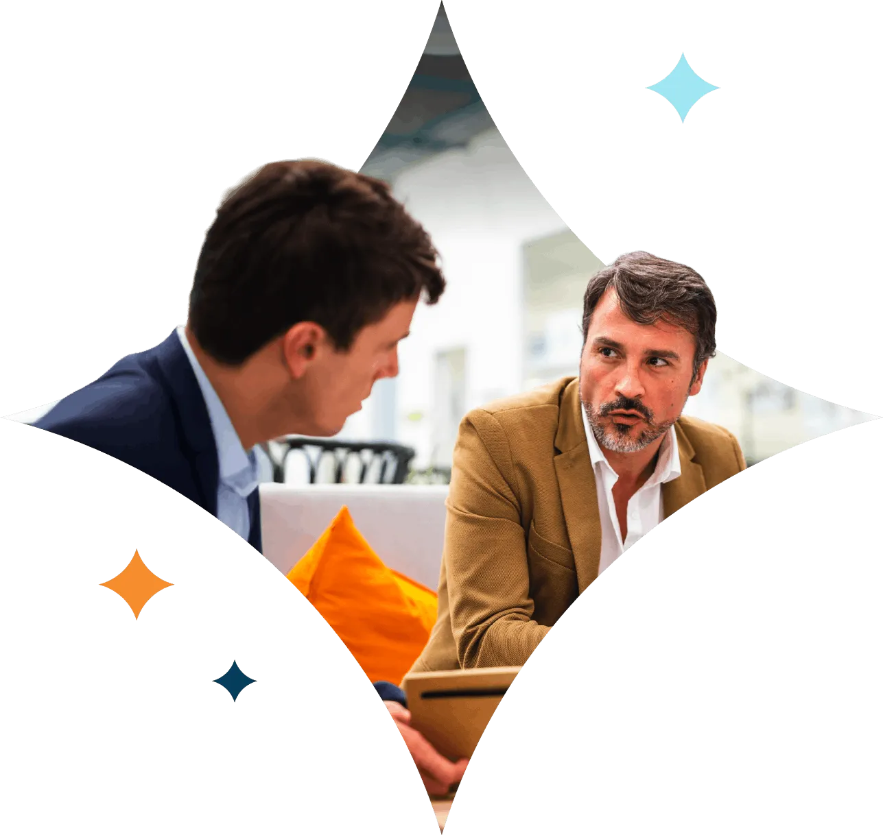 Two businessmen having a serious discussion on a couch, one holding a tablet.