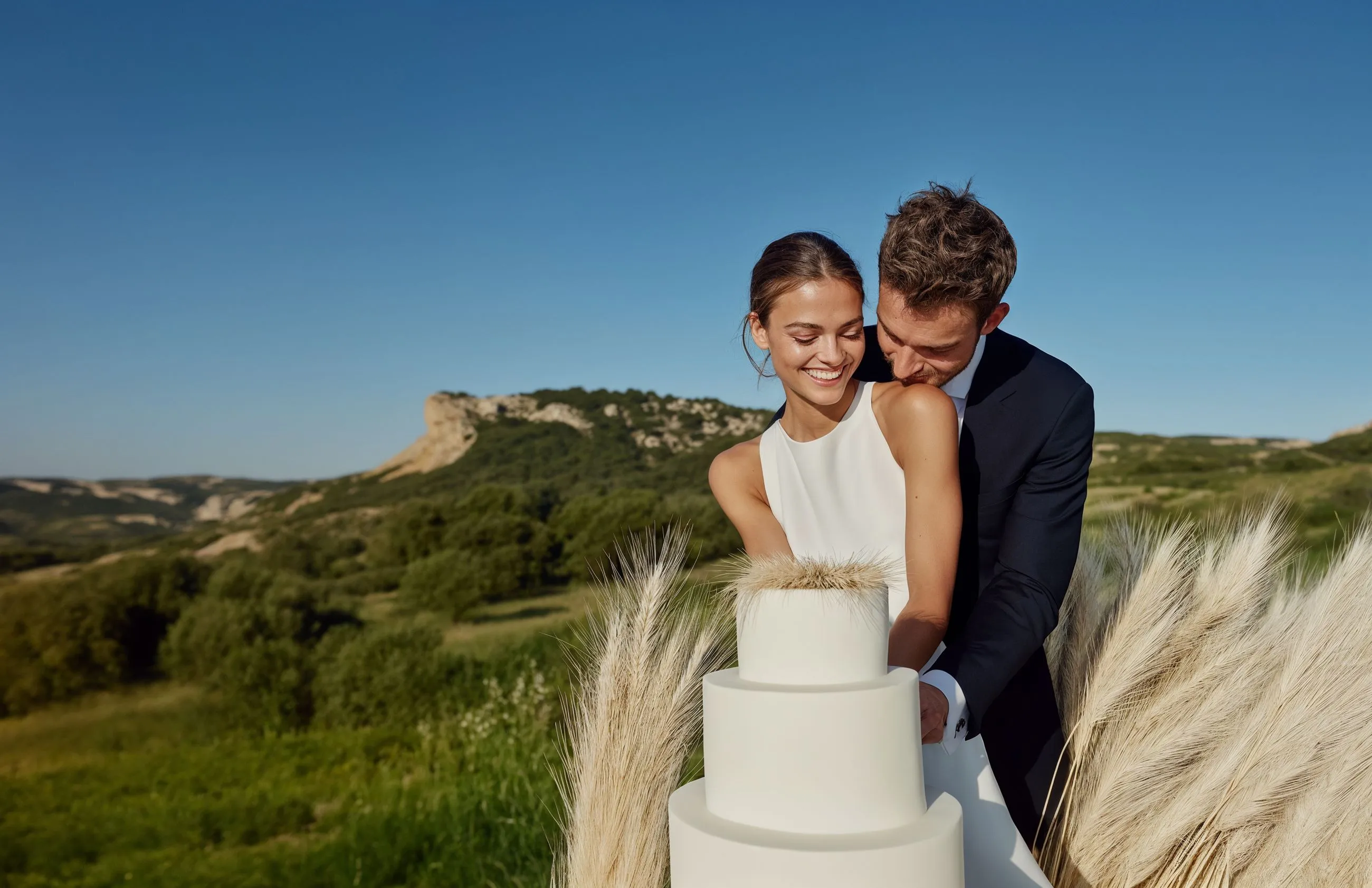 A bride and groom cutting their wedding cake.