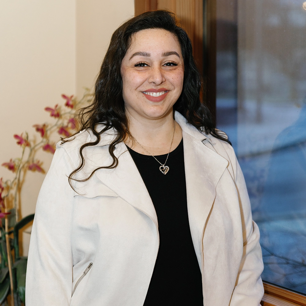 Gabriela Carrillo, younger Hispanic female with long curly brown hair and a warm smile