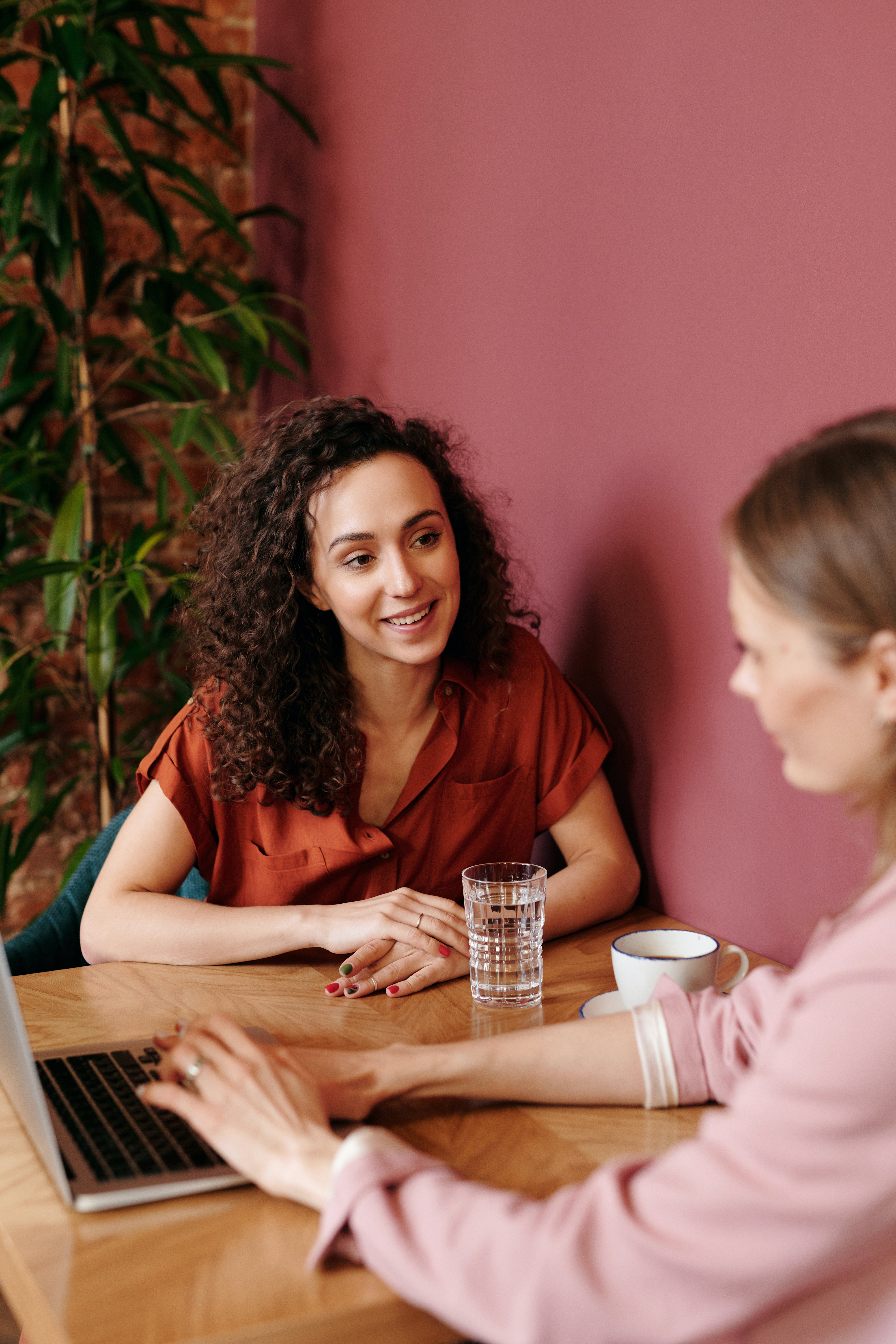 Two women working on a laptop stock image