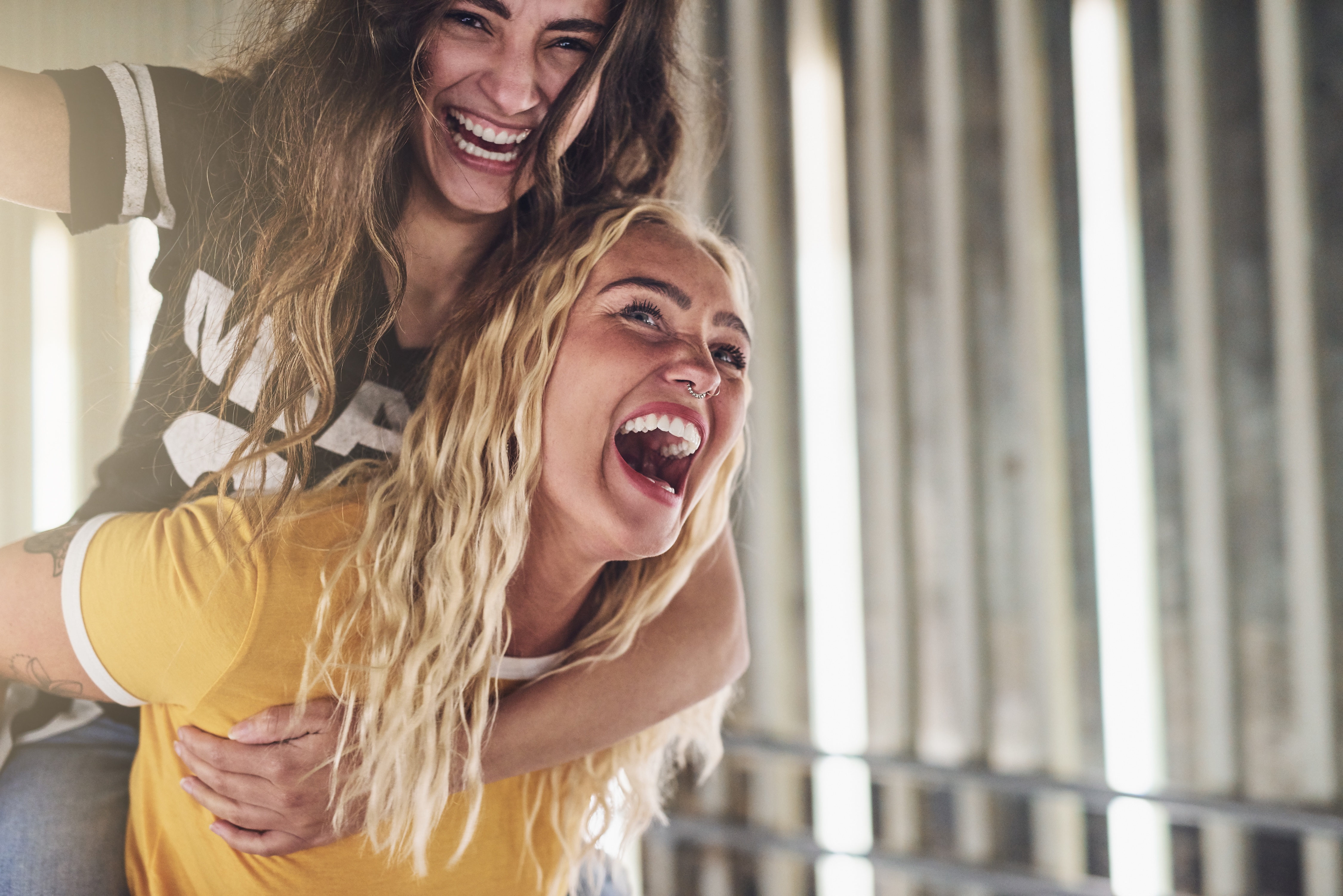 Woman giving a piggy back ride stock image
