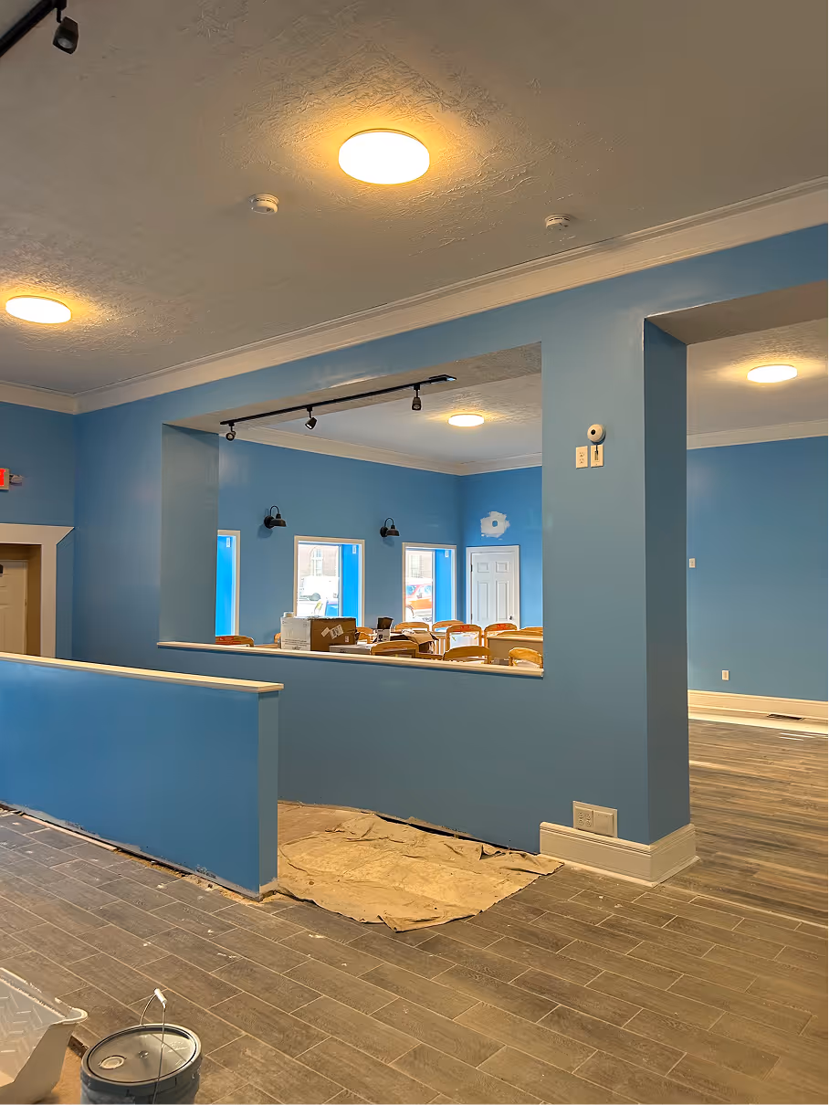 Framed interior wall and service counter structure under construction inside daycare renovation.