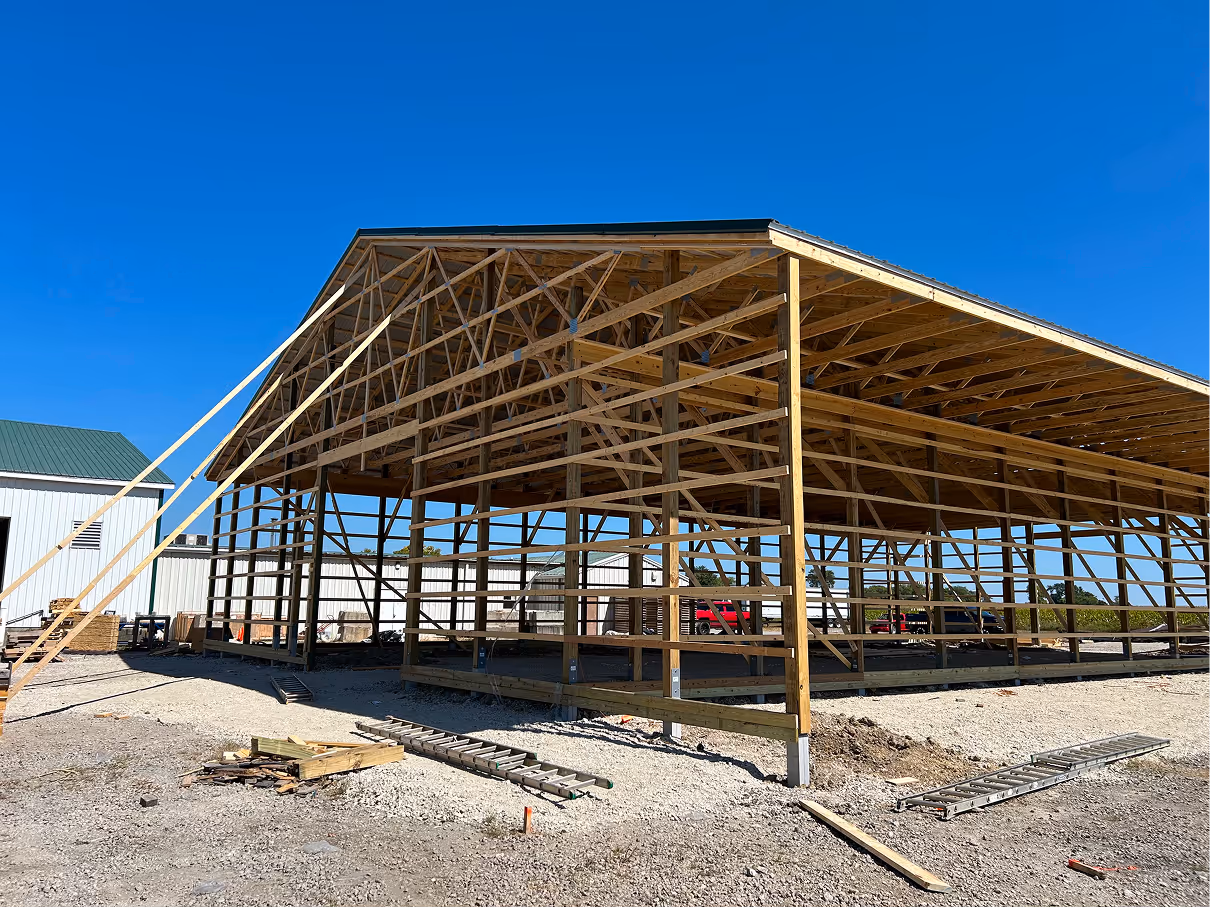 Close-up of roof framing showing wood trusses and metal connector plates.