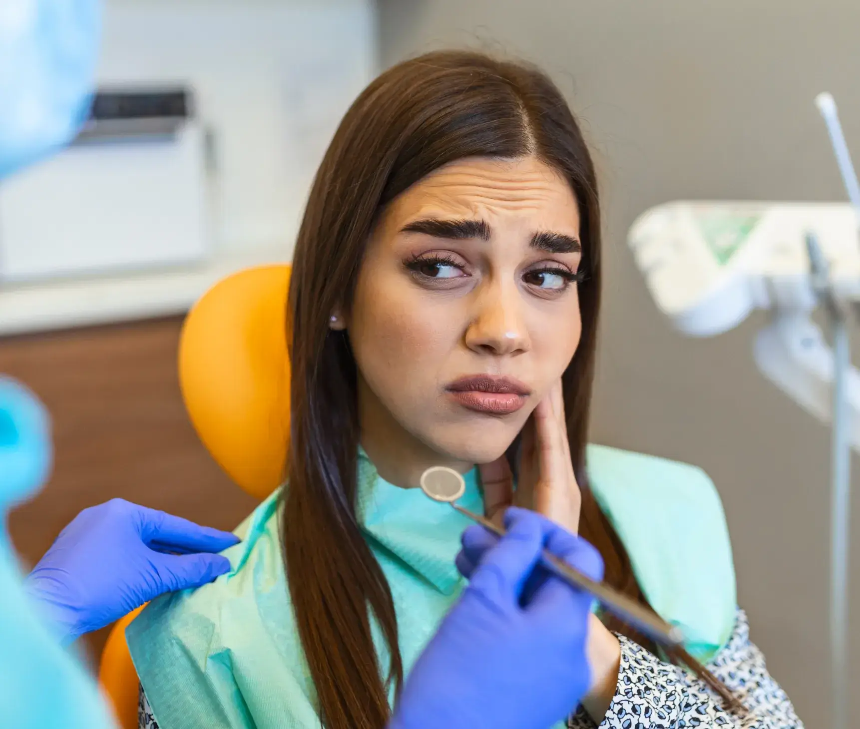 A woman getting her teeth checked by a dentist.