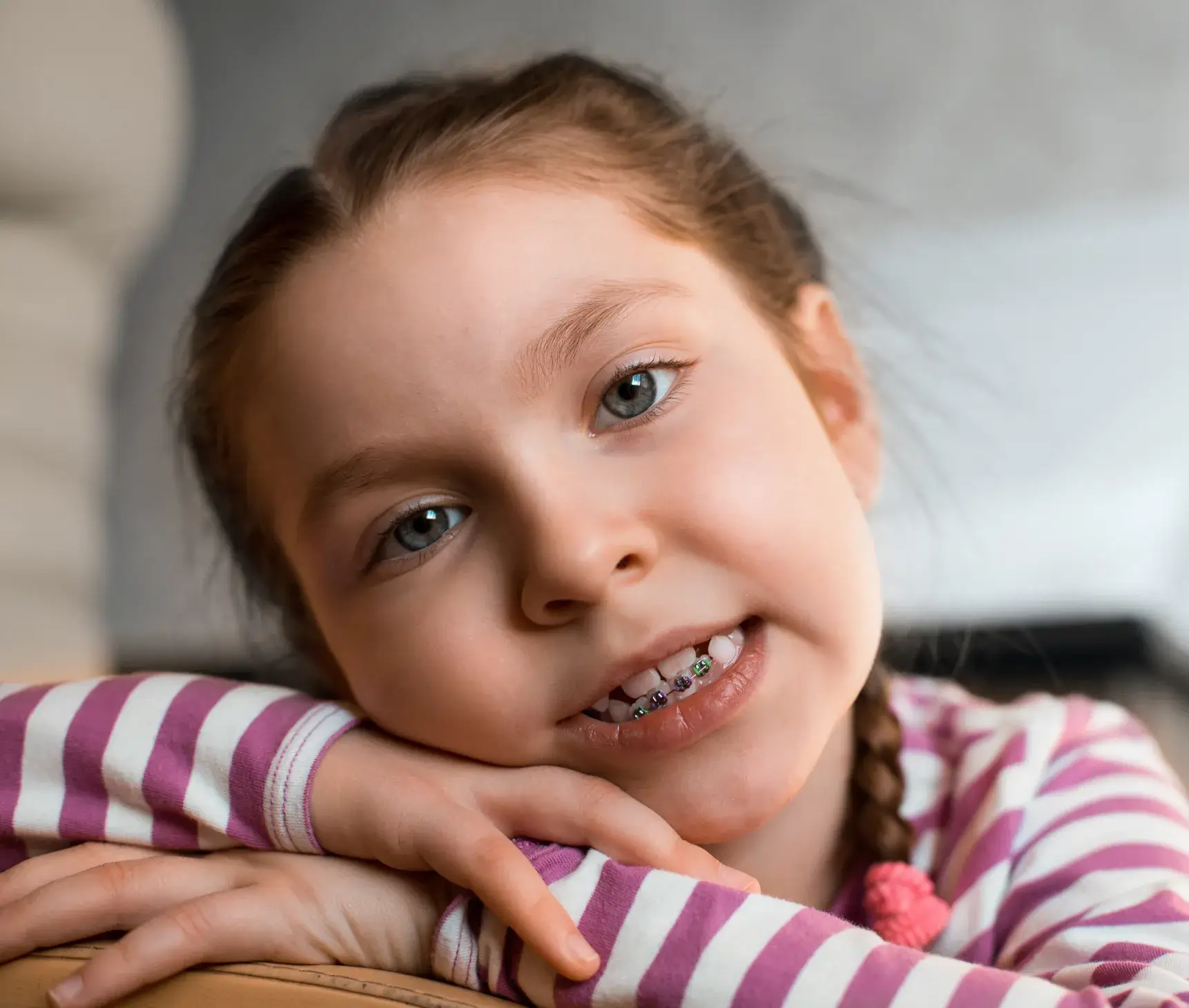 A little girl with braces on her teeth.
