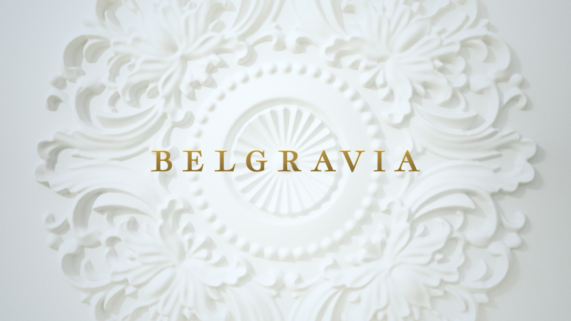 Ornate white plaster ceiling medallion with the word BELGRAVIA in gold lettering across the center.