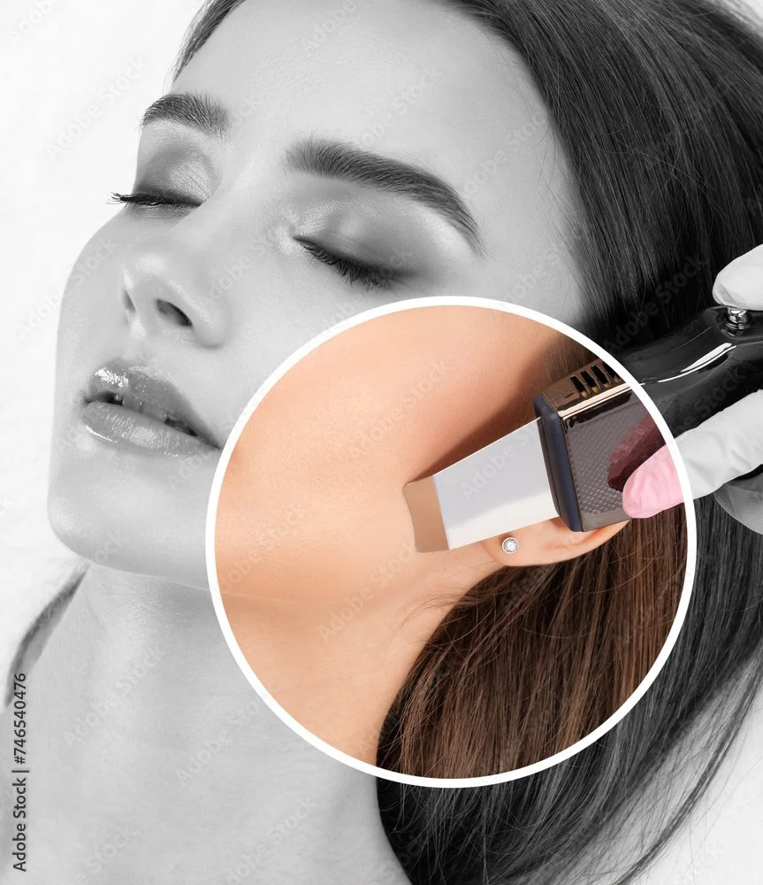 Close-up of a woman with eyes closed receiving a facial treatment using an ultrasonic skin scrubber near her jawline.