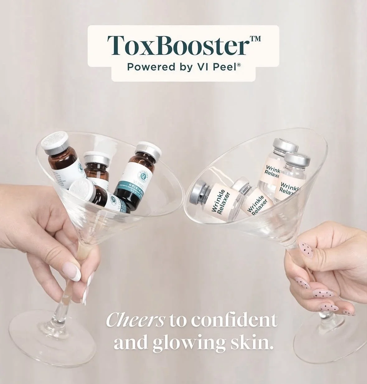 Two hands holding martini glasses filled with skincare vials labeled 'Wrinkle Relaxer' and 'VI Peel' under the text 'ToxBooster Powered by VI Peel' and the caption 'Cheers to confident and glowing skin.'