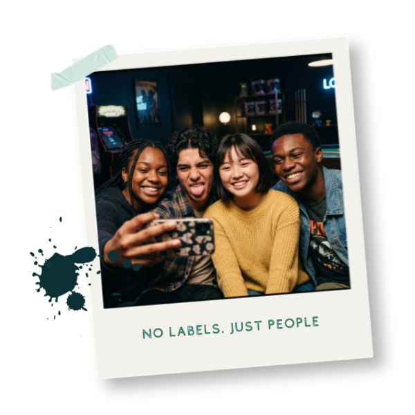 Group of four diverse friends smiling and taking a selfie together indoors.