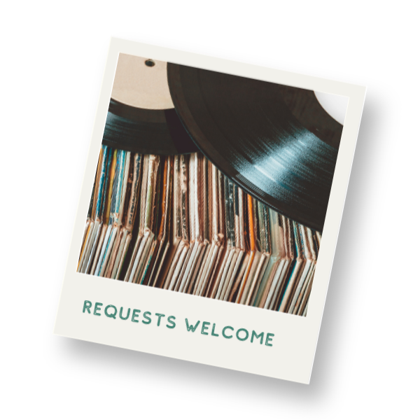 Two vinyl records on top of a collection of record sleeves with text that reads 'REQUESTS WELCOME'.