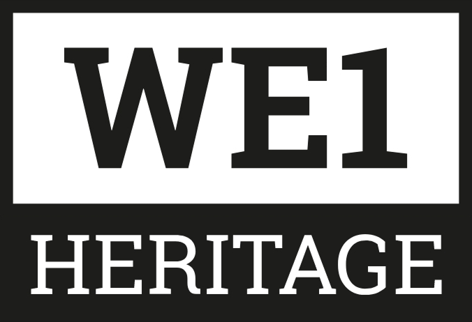 WE1 Heritage logo. Black and white logo with 'WE1' in a white rectangle and the word 'HERITAGE' below it.