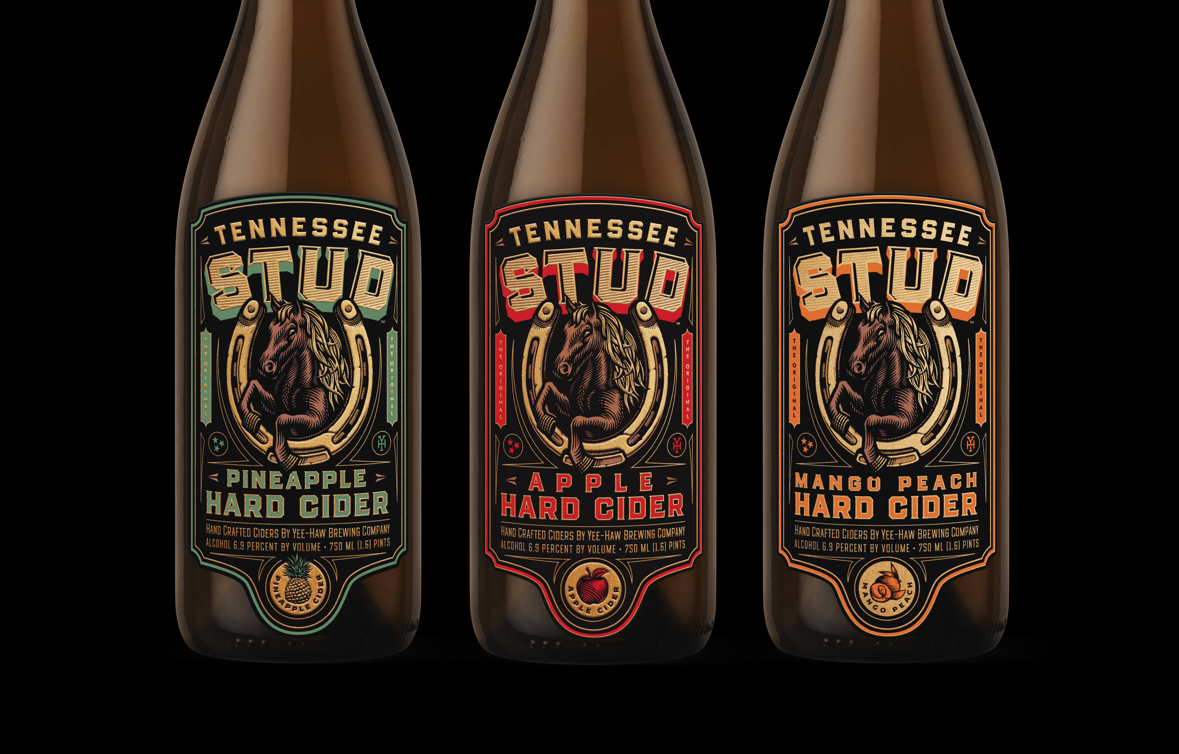 Three bottles of Tennessee Stud hard cider with different flavors and colorful labels featuring a horse inside a horseshoe: Pineapple Hard Cider with green accents, Apple Hard Cider with red accents, and Mango Peach Hard Cider with orange accents. Each label notes 6.9 percent alcohol by volume and handcrafted by Yee-Haw Brewing Company.