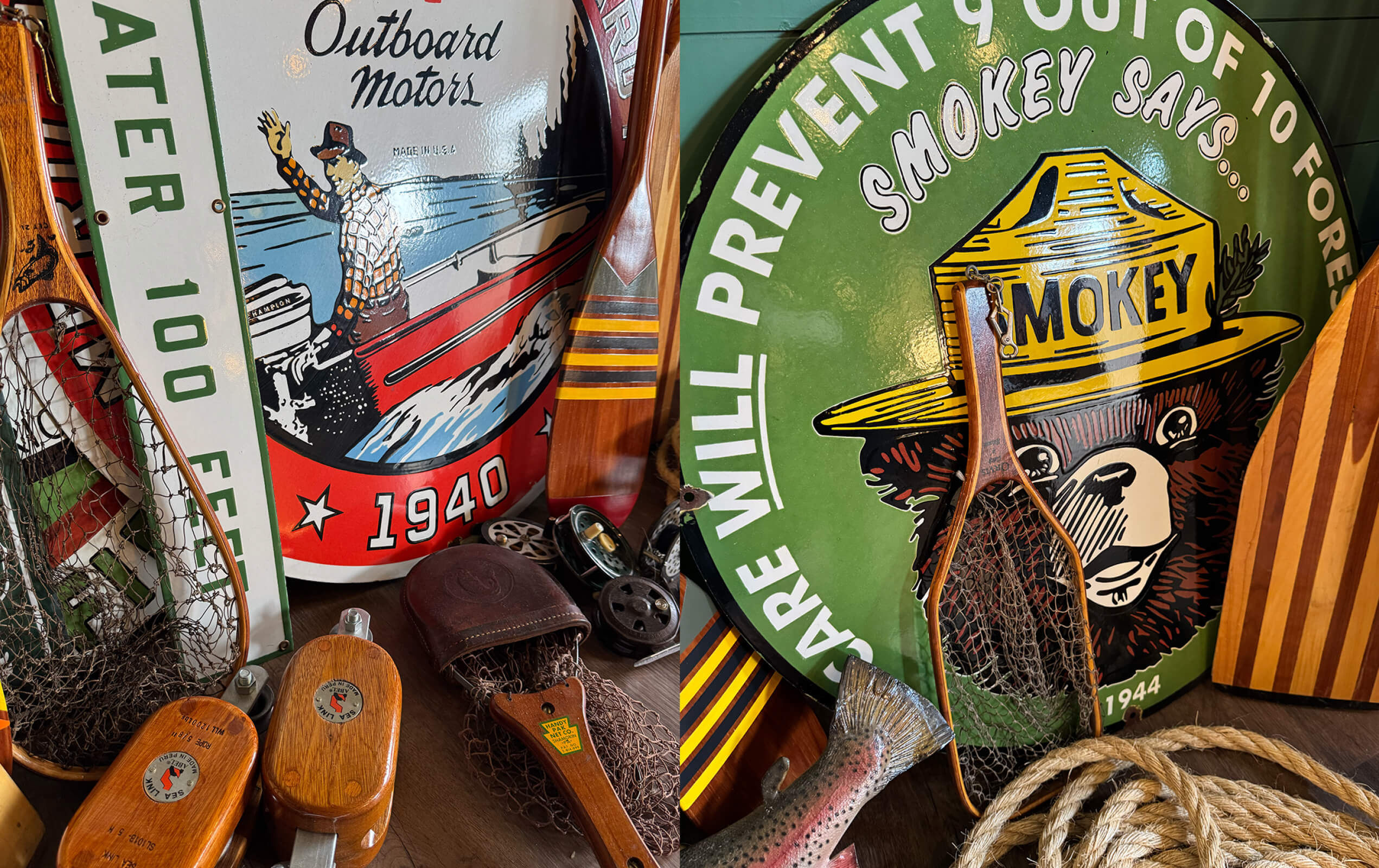 Vintage fishing-themed decorations including a round metal sign with a fisherman in a red boat and the text 'Outboard Motors 1940', another green round sign with Smokey Bear wearing a ranger hat and the words 'Care will prevent 9 out of 10 forest fires 1944', wooden fishing nets, reels, a rope coil, and a fish sculpture on a wooden surface.