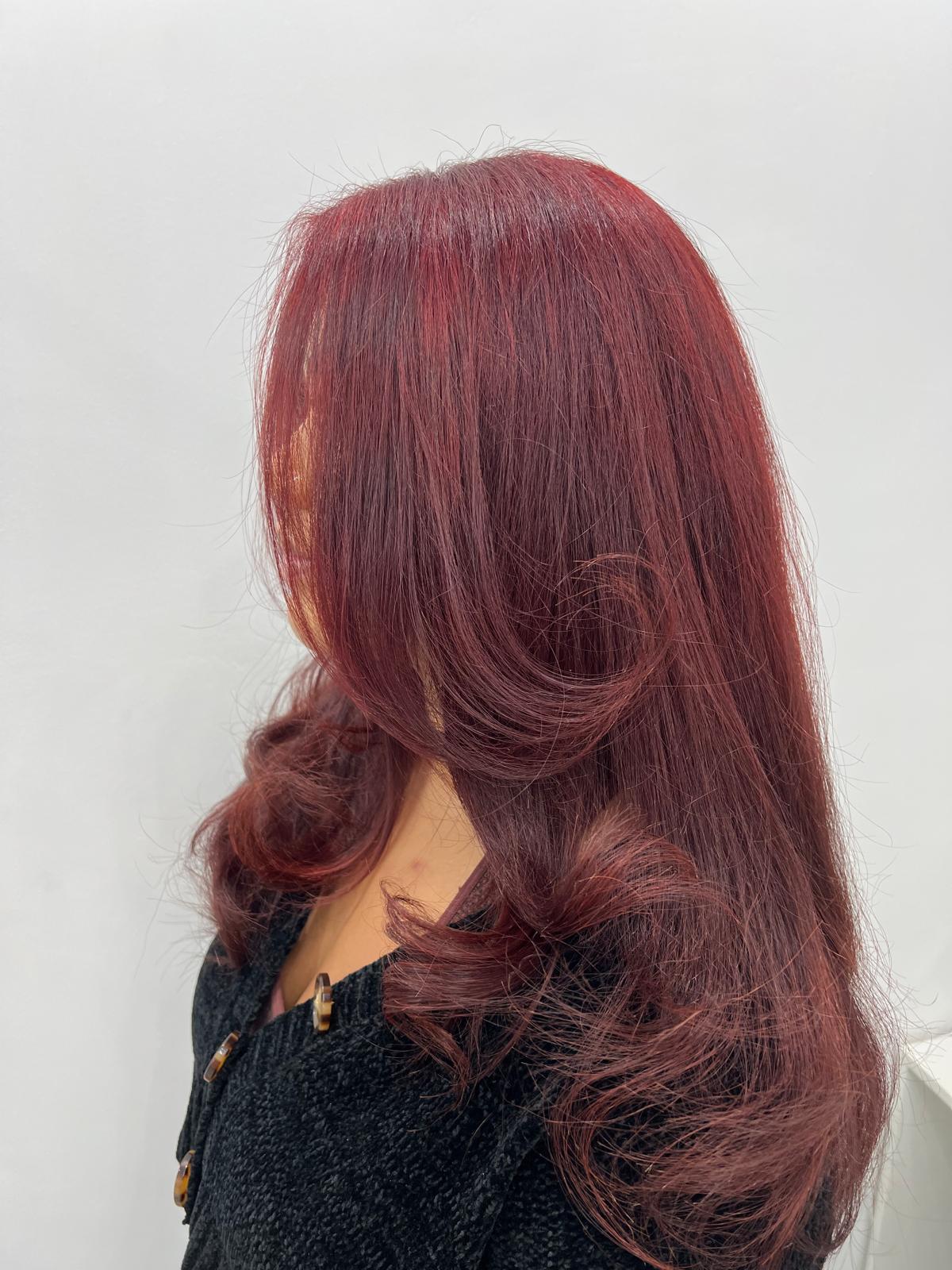 Side profile of a woman with long, straight platinum blonde hair