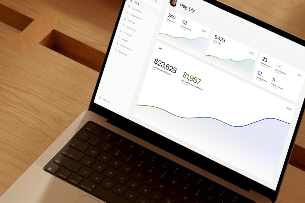 Laptop on wooden table showing a dashboard with user stats including subscriptions, user signups, daily event count, and monthly revenue graphs.