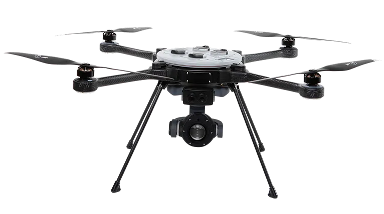 Black hexacopter drone with six propellers and a mounted camera gimbal underneath.
