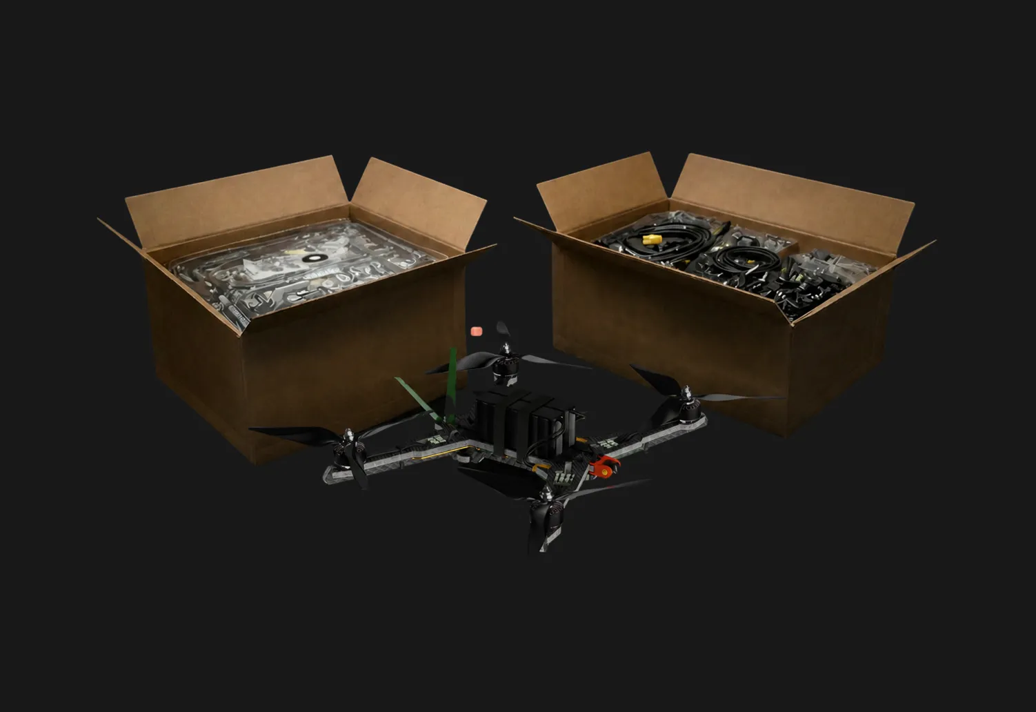 A quadcopter drone with black propellers is placed between two open boxes filled with drone parts.