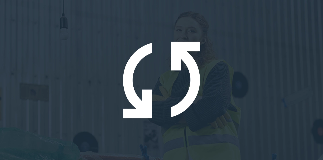 Overlay of a white refresh or sync icon on a dimmed image of a woman in a safety vest standing indoors.