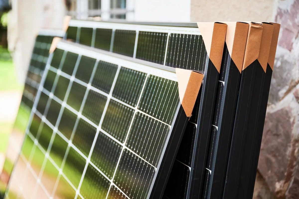 Decommissioned solar panels stacked for specialist recycling