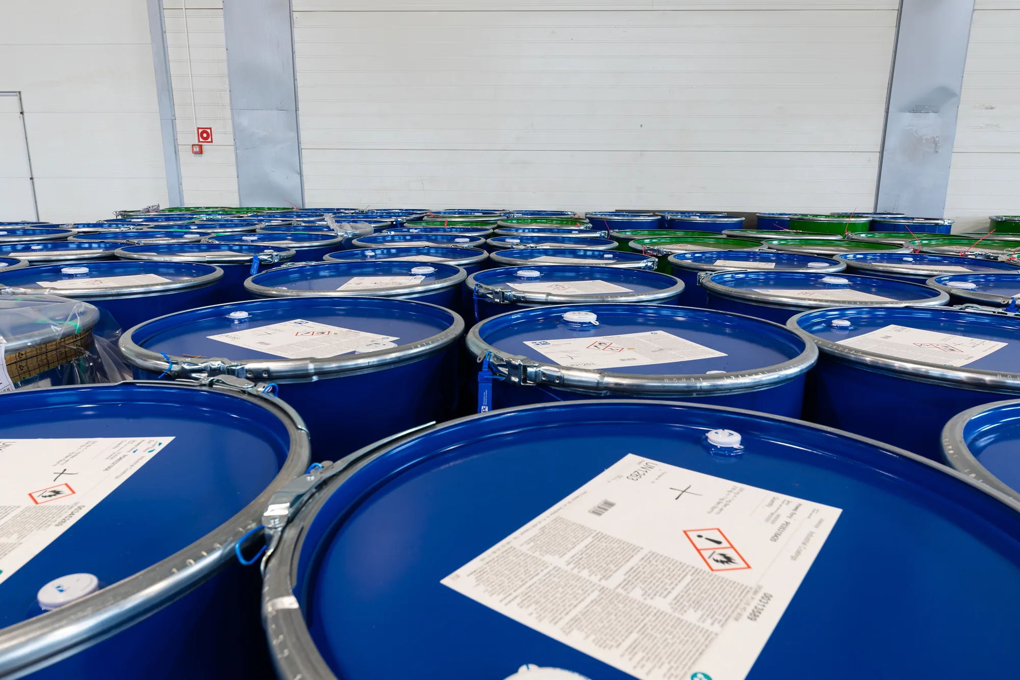 Labelled hazardous waste drums in segregated storage