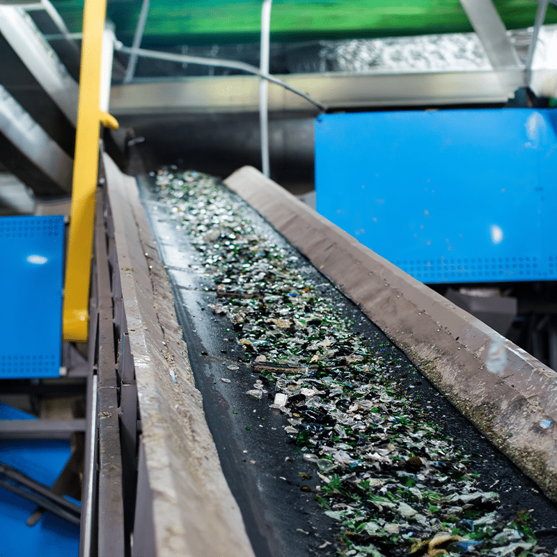 Conveyor carrying electrical waste through a recycling facility