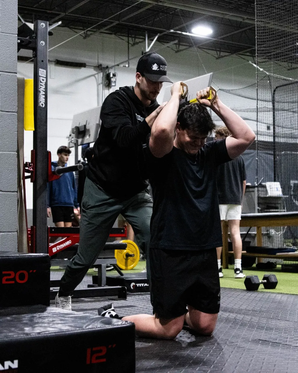 An athlete performing the Dumbbell Tate Press, a highly effective triceps-isolation exercise often used to build lockout strength for pressing movements