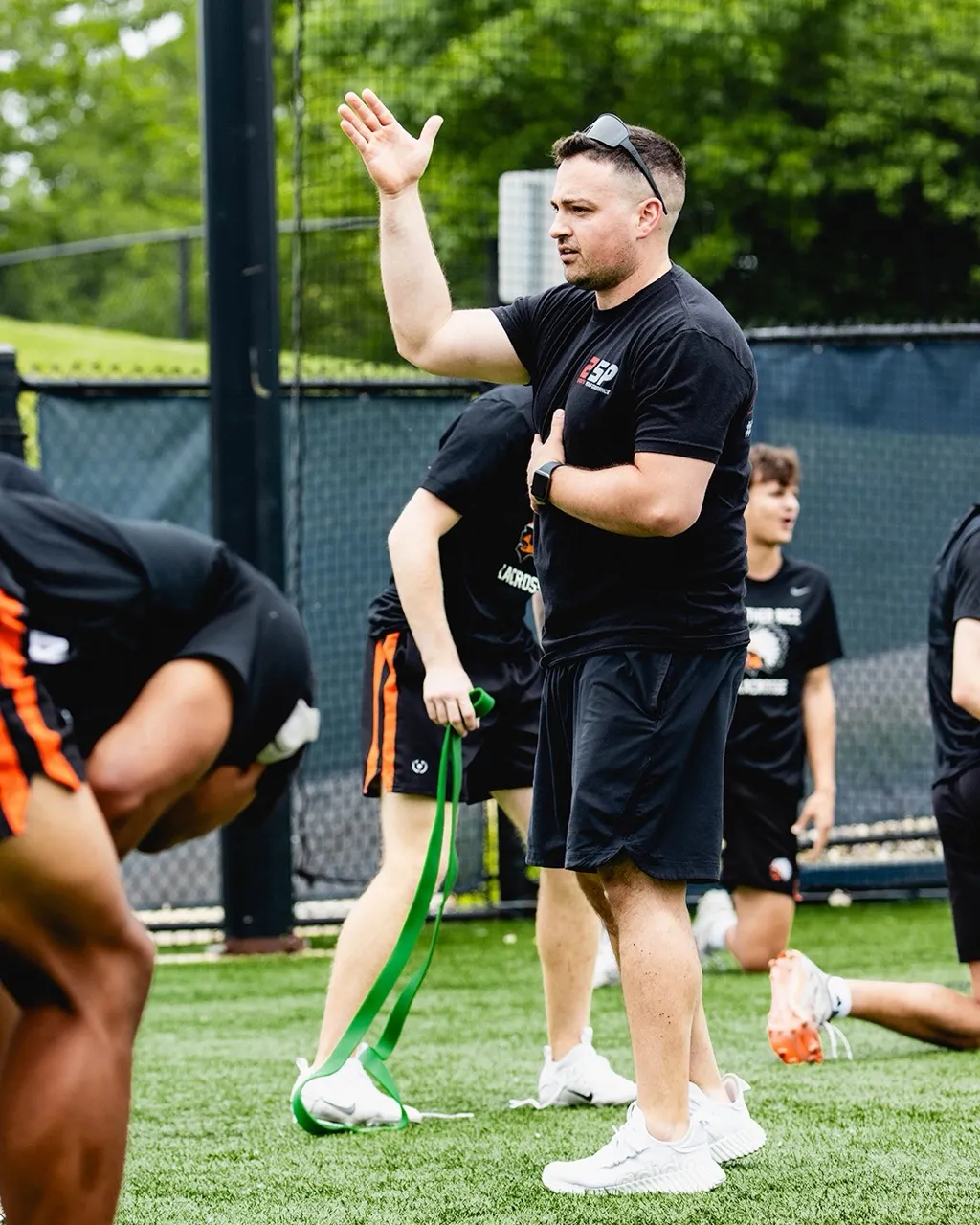 Strength and conditioning coach Joe Fava of 2SP Sports Performance leading a pre-game or practice warm-up session.