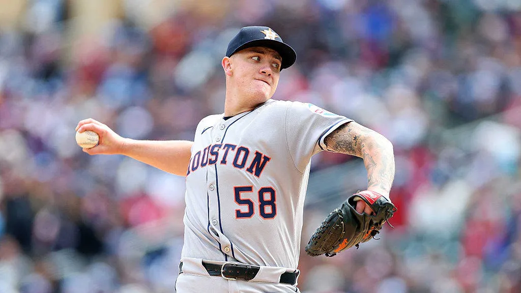 Houston Astros pitcher in gray uniform with number 58 throwing a baseball during a game.