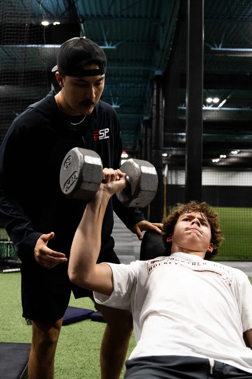 Coach guiding an athlete through 2SP Foundations training