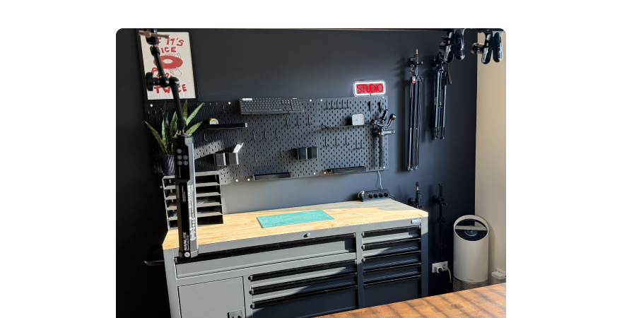 The new photography space with a workbench, pegboard and studio lighting