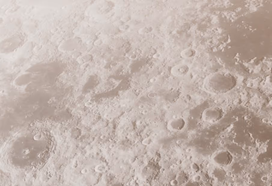 Close-up view of the Moon's surface showing numerous craters and rough terrain.