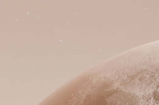 Close-up view of a planet's surface with craters against a starry beige sky.