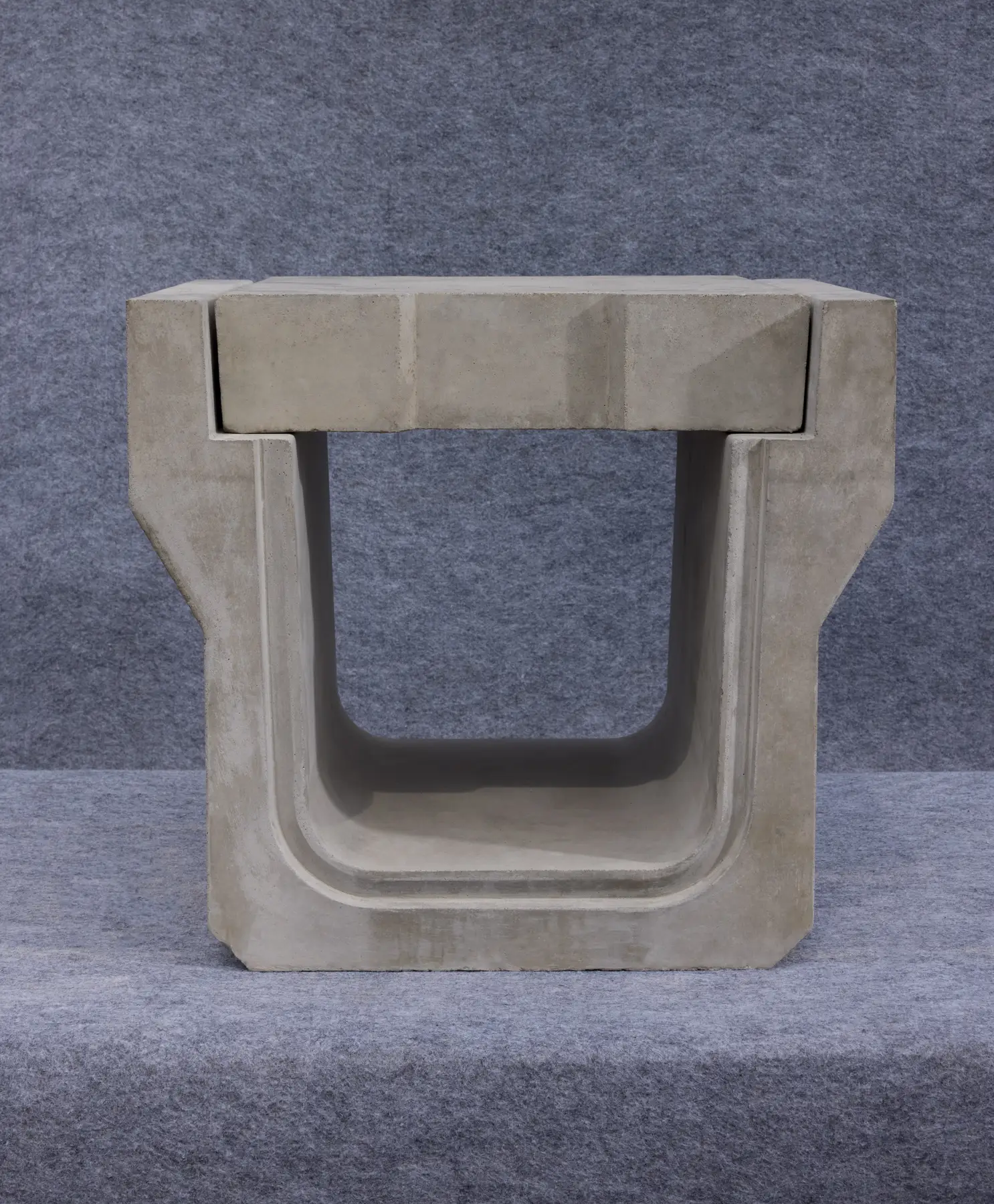 Precast concrete U-shape drain with a fitted cover, shown in cross-section on a grey backdrop