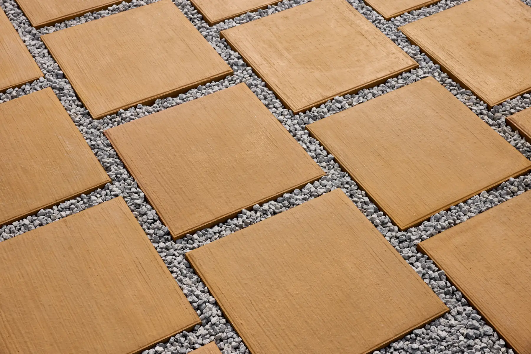 Yellow Teak flagstones with a wood-grain texture, laid in a staggered pattern with gravel joints
