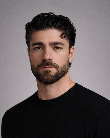 A man wearing a black turtle neck sweater.