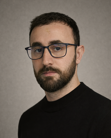 A man with a black shirt and a black jacket.