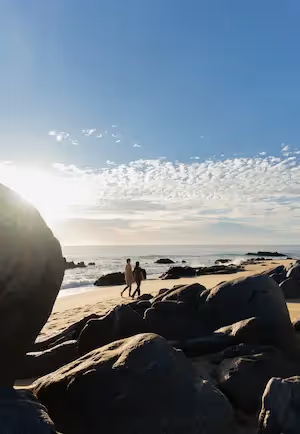 Pristine beach and rocky shoreline under a bright blue sky, La Valise Los Cabos.
