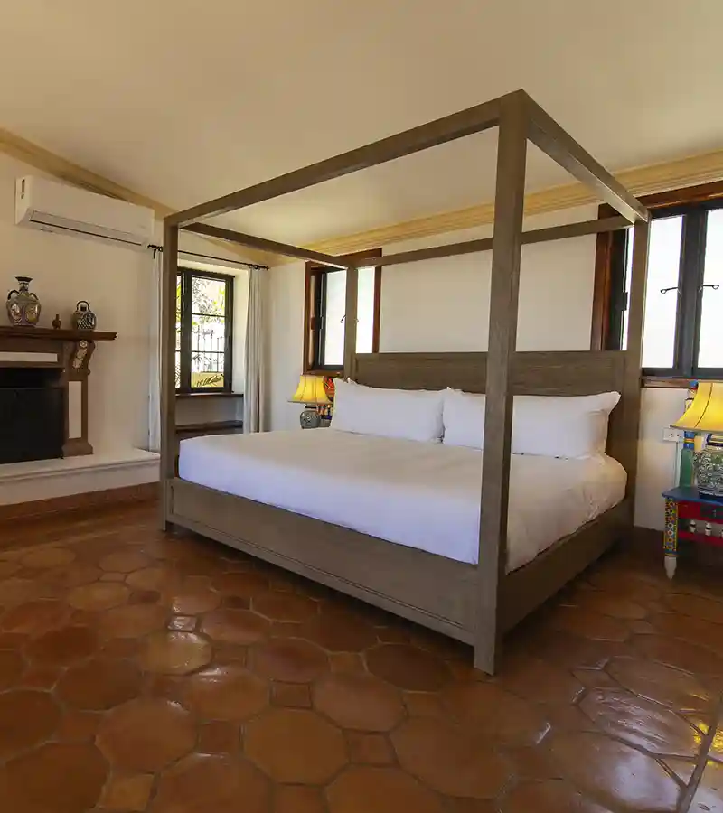 A serene king suite featuring a shared terrace with garden and ocean views.