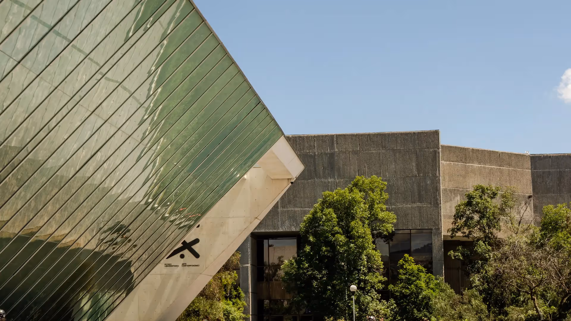 Exterior view , showcasing the futuristic architecture of the Soumaya Museum reflecting in a water pool.