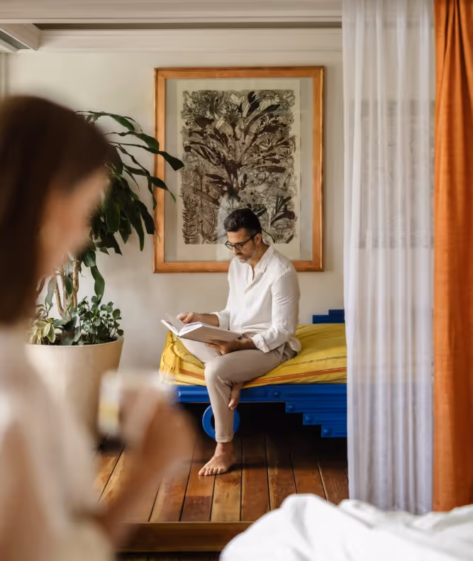 Guest reading in a bright and stylish suite at La Valise Mexico City Hotel.