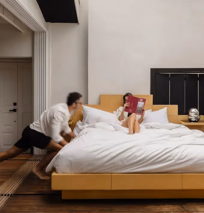 Luxury suite at La Valise Mexico City hotel featuring a signature sliding king-size bed leading to the terrace.