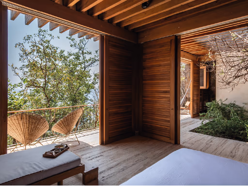 Private terrace with rattan chairs and organic design at La Valise Mazunte Hotel.