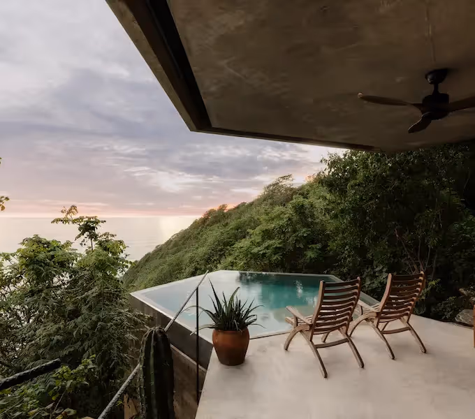 Exterior view of the luxury boutique at La Valise Tulum hotel surrounded by lush tropical jungle in Mexico.
