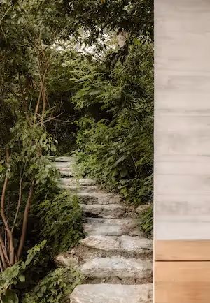 Stone slab pathway through the tropical garden at La Valise Mazunte Hotel.