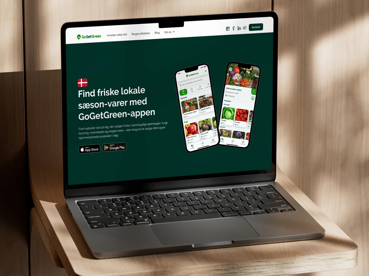 Bærbar computer på trækasse viser GoGetGreen-appens ny hjemmeside